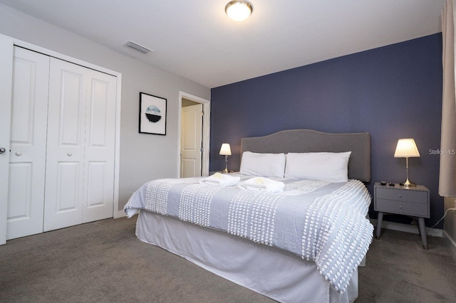 bedroom featuring a closet and dark carpet