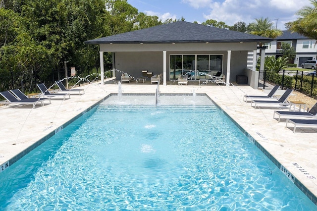 view of pool with pool water feature and a patio area