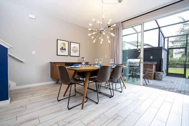 dining space with light wood-type flooring and a chandelier