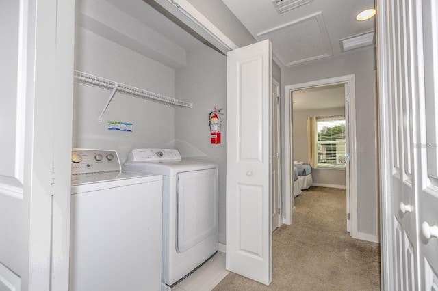 washroom featuring separate washer and dryer and light carpet