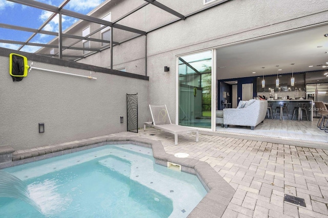 view of pool featuring a lanai and a patio area