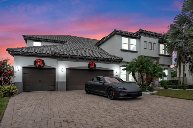 mediterranean / spanish-style house featuring a garage