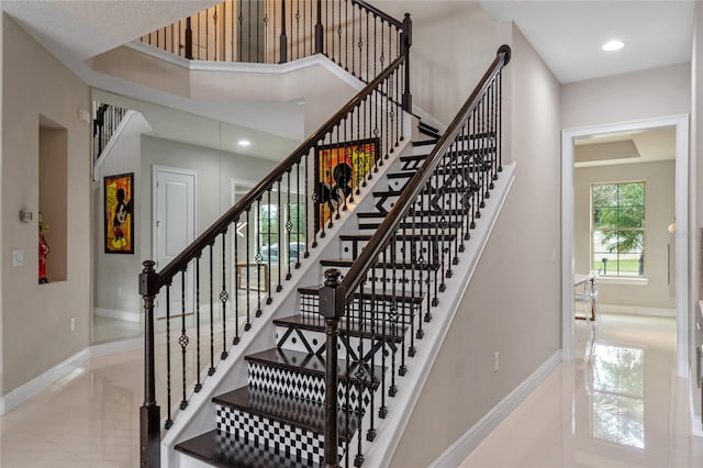 staircase featuring tile patterned floors