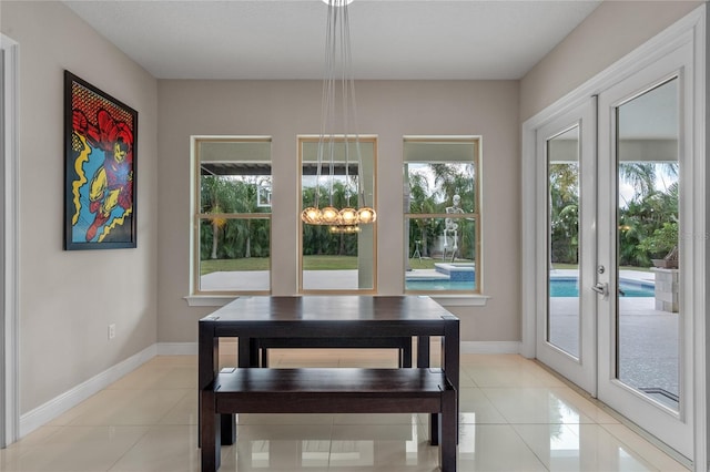 dining area featuring french doors and light tile patterned floors