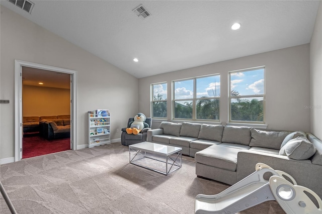 living room with a textured ceiling, carpet floors, and vaulted ceiling