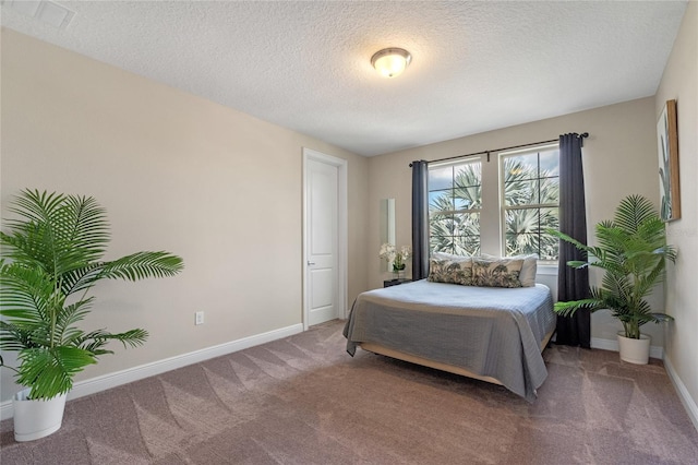 bedroom featuring carpet floors and a textured ceiling