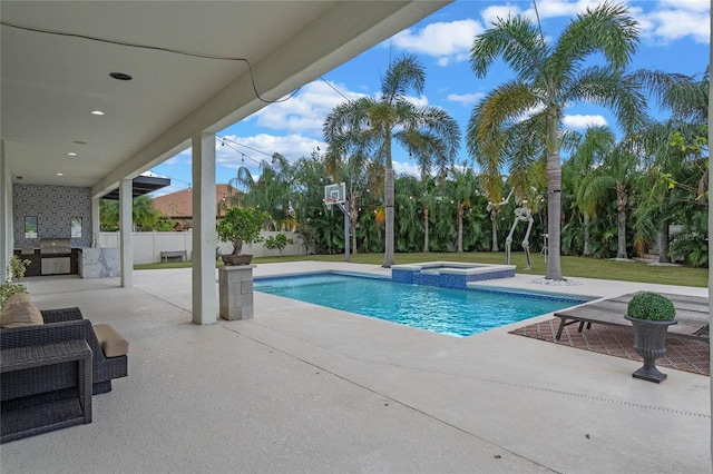 view of pool with a patio area, an in ground hot tub, and exterior kitchen