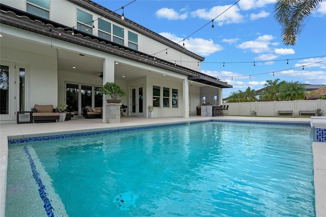 view of swimming pool featuring a patio, an outdoor hangout area, and ceiling fan