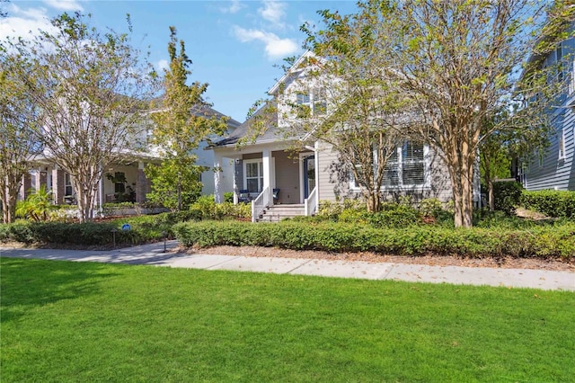 view of front of home featuring a front yard and a porch