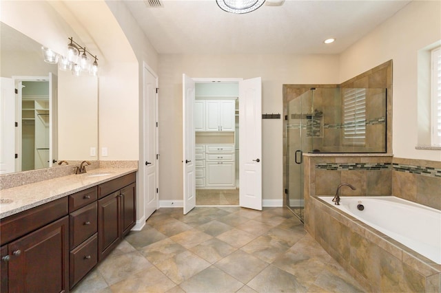 bathroom with shower with separate bathtub and vanity