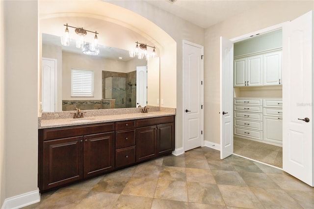 bathroom featuring vanity and an enclosed shower