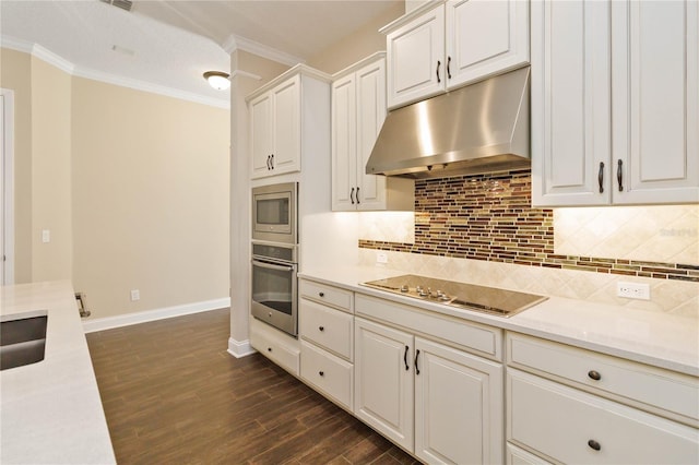 kitchen featuring white cabinets, dark hardwood / wood-style floors, ornamental molding, tasteful backsplash, and stainless steel appliances