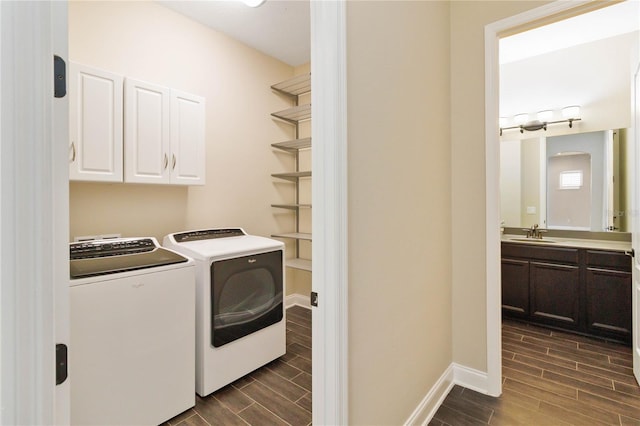 laundry room featuring cabinets, sink, and washer and dryer