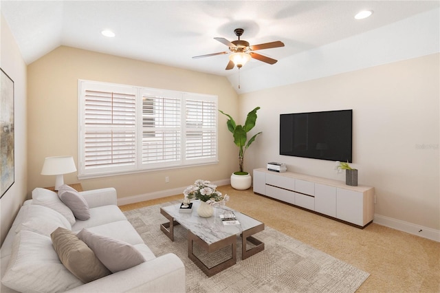 carpeted living room with ceiling fan and lofted ceiling