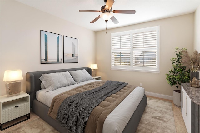 bedroom with ceiling fan and light carpet