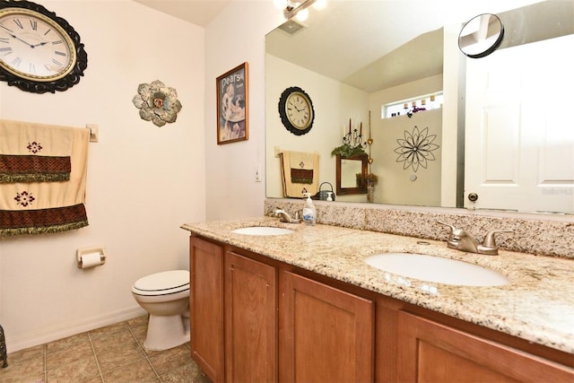 bathroom featuring tile patterned flooring, vanity, and toilet