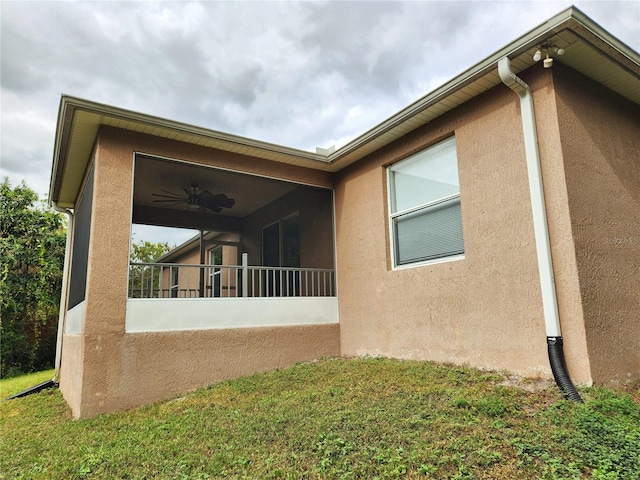 view of side of home with a yard