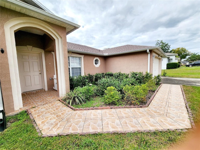 doorway to property with a garage