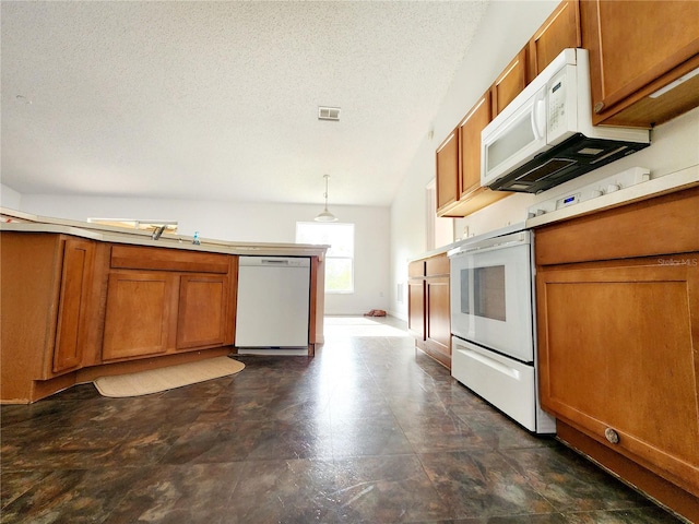 kitchen featuring a textured ceiling, white appliances, vaulted ceiling, sink, and decorative light fixtures