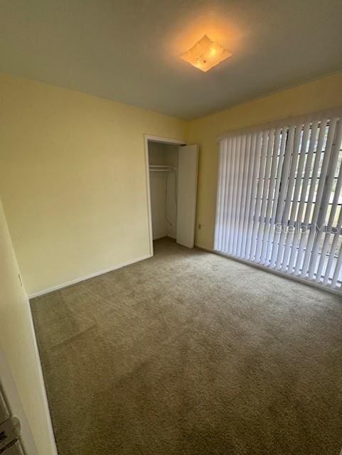 unfurnished bedroom featuring a closet and carpet