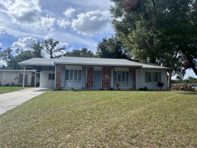 ranch-style home with a front yard and a carport