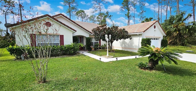 view of front of property featuring a garage and a front yard