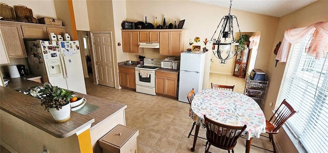 kitchen featuring light tile patterned floors, pendant lighting, and white appliances