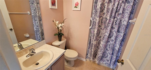 bathroom featuring tile patterned flooring, vanity, toilet, and walk in shower