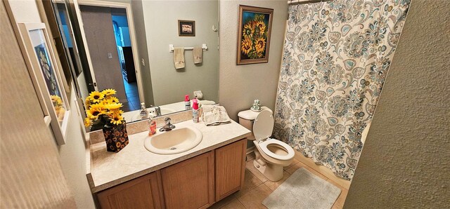 bathroom featuring a shower with curtain, tile patterned flooring, vanity, and toilet