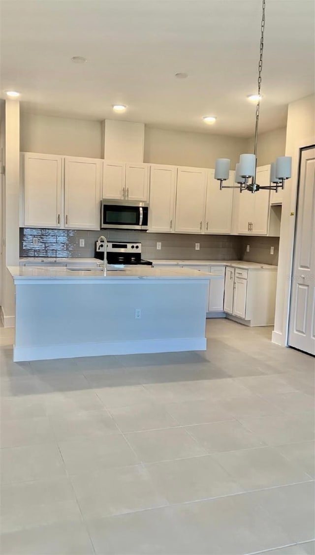 1541 Heritage Pl, Oviedo, FL 32765 - kitchen with stainless steel appliances, white cabinetry, light countertops, backsplash, and recessed lighting