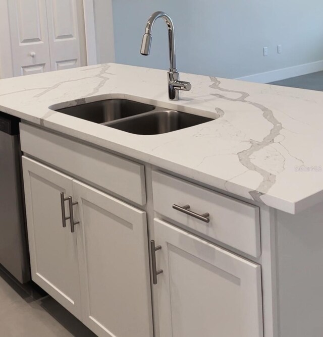 1541 Heritage Pl, Oviedo, FL 32765 - kitchen featuring a sink, light stone countertops, white cabinets, and dishwasher