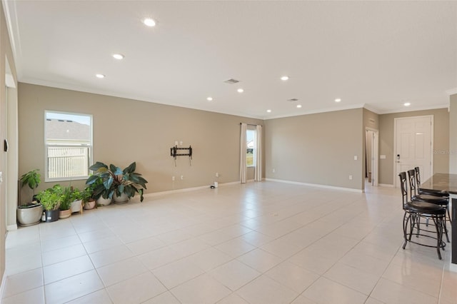 interior space featuring ornamental molding and light tile patterned flooring