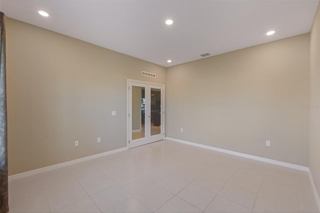 empty room with french doors and light tile patterned floors