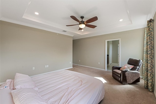 bedroom with ceiling fan, light carpet, crown molding, and a tray ceiling