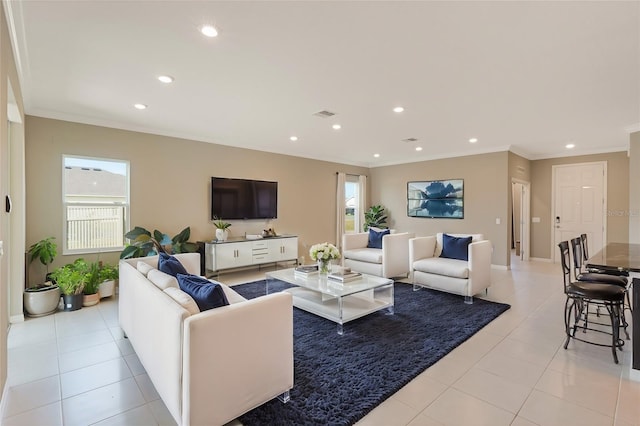 tiled living room featuring plenty of natural light and crown molding