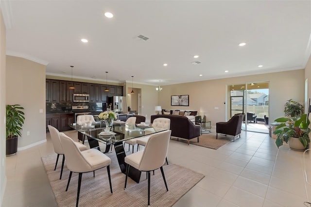 dining area featuring light tile patterned floors and ornamental molding