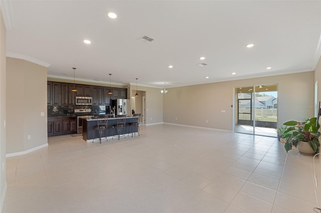 living room with light tile patterned floors and ornamental molding