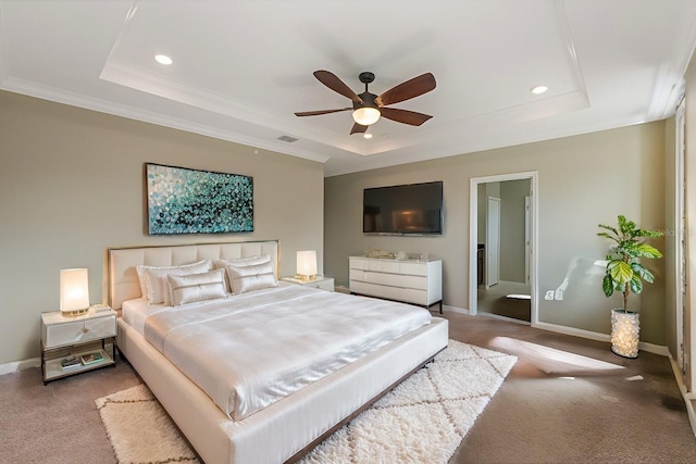 bedroom with carpet floors, ensuite bathroom, ceiling fan, and a raised ceiling