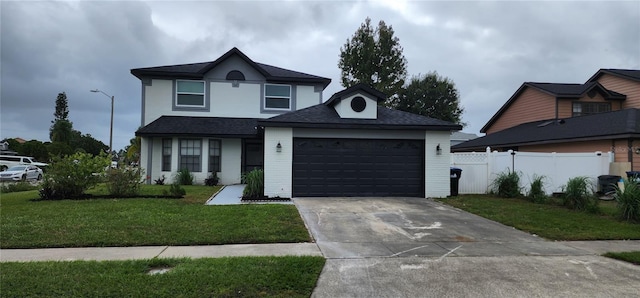 view of front of house featuring a garage and a front yard