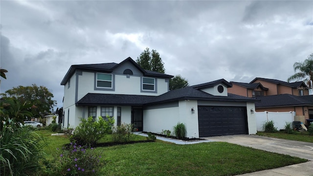 view of front of house with a garage and a front lawn