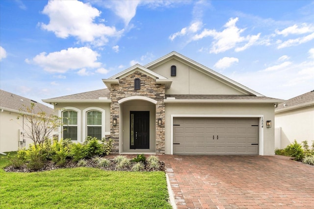 view of front of property with a garage and a front lawn