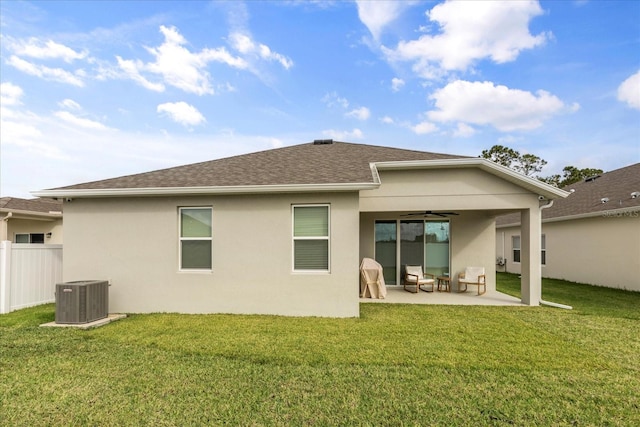 rear view of property with a lawn, ceiling fan, cooling unit, and a patio