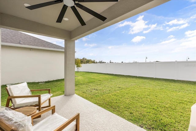 view of yard featuring ceiling fan and a patio