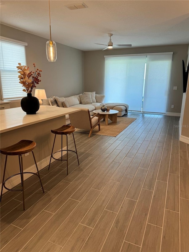 living room featuring dark hardwood / wood-style flooring and ceiling fan