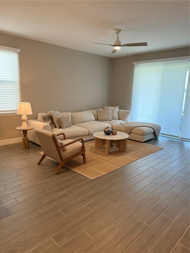 living room featuring hardwood / wood-style floors and ceiling fan