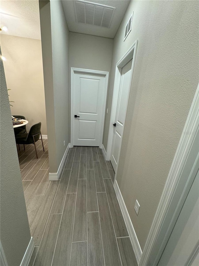 hallway featuring wood-type flooring