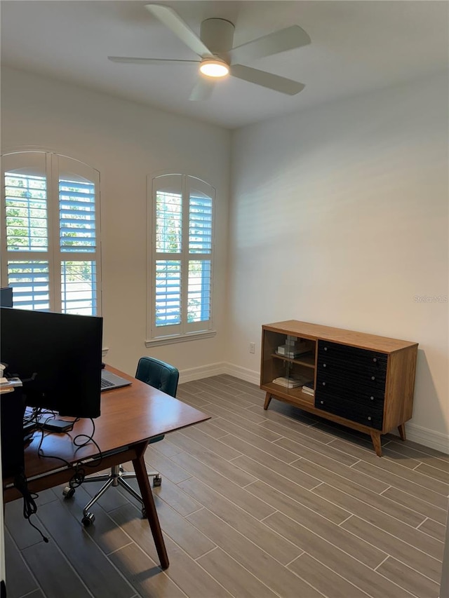 office with hardwood / wood-style floors, ceiling fan, and a healthy amount of sunlight