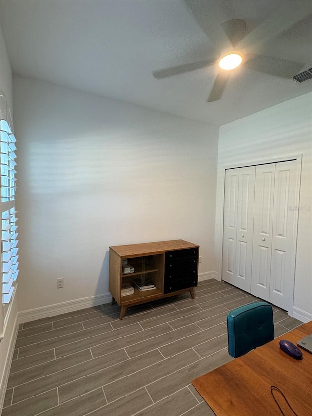 unfurnished office featuring ceiling fan