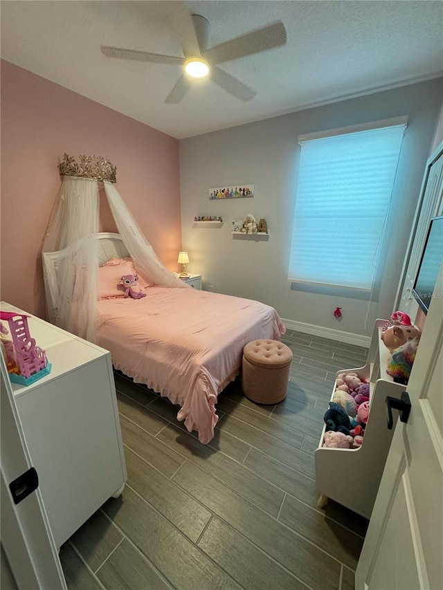 bedroom with ceiling fan and dark wood-type flooring