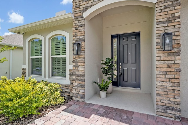 1554 Outback Rd W, Saint Cloud, FL 34771 - doorway to property featuring stone siding and stucco siding